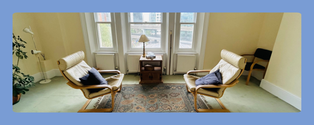 Bright and calming professional therapy room in Little Venice, London, featuring comfortable armchairs and neutral decor.